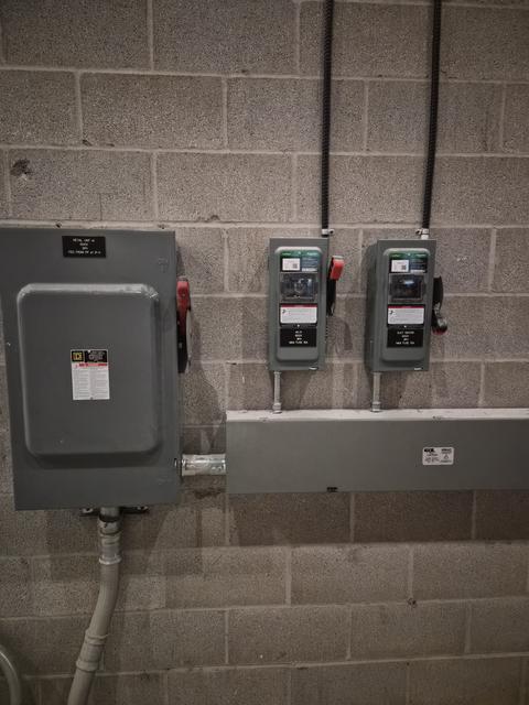 Electrical panels and disconnect switches on concrete wall