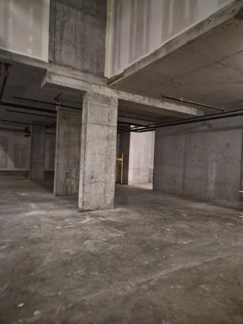 Bare concrete retail floor before the electrical fit-out
