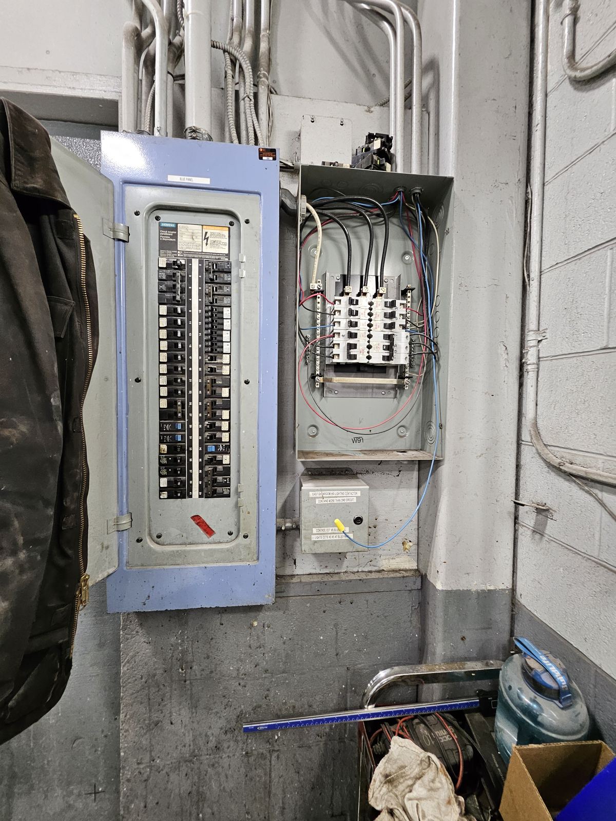 Licensed electrician troubleshooting an electrical distribution panel