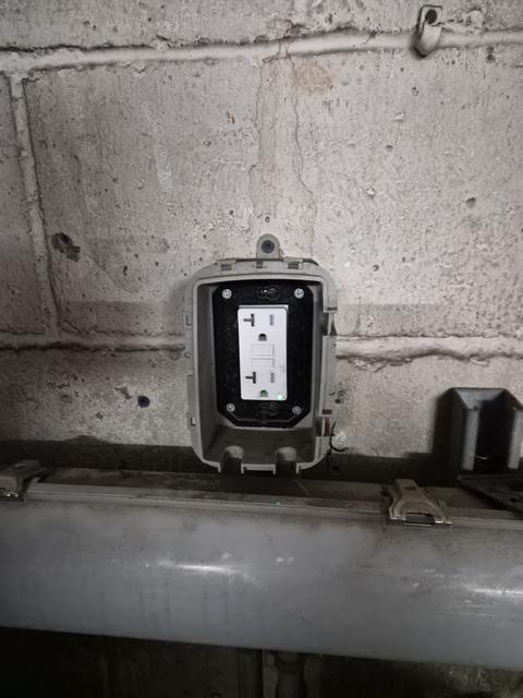 Exterior electrical receptacle installed on brick wall